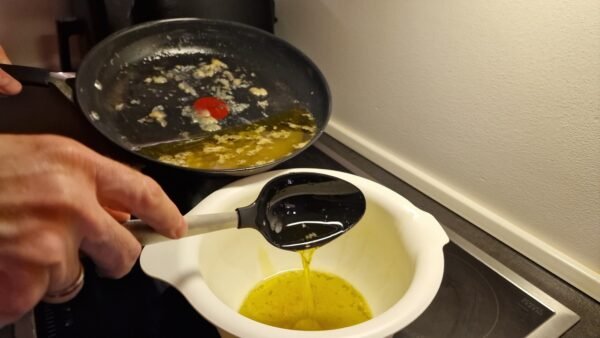Olivenöl wird in ein separates Gefäß gelöffelt