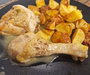 Pollo al ajillo mit Bratkartoffeln auf einem Teller